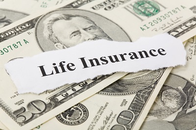 image of life insurance sign on top of money